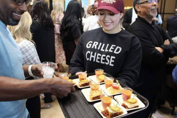 Ruthie’s For Good team member serving grilled cheese samples at a catering event
