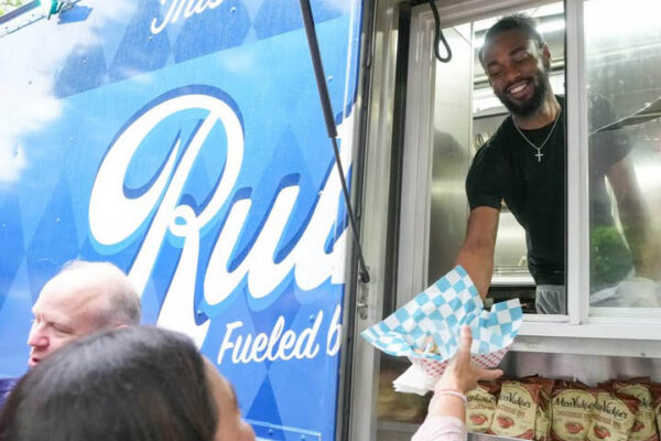 Ruthie’s For Good team serving grilled cheese from food truck at a Dallas catering event
