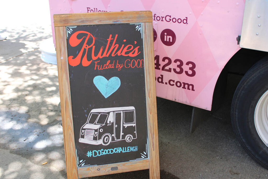Ruthie’s For Good catering sign and food truck setup at a Dallas event