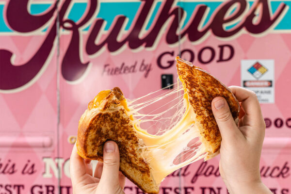 Ruthie’s For Good grilled cheese sandwich with melted cheese pull in front of food truck